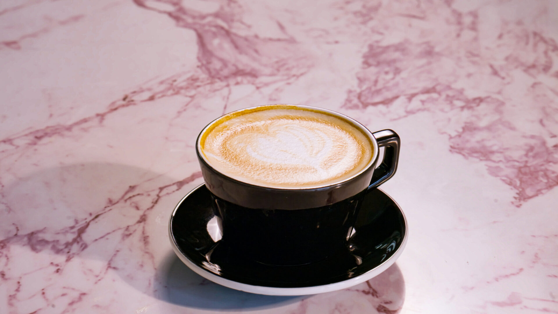 Iced latte with foam art at French Press Bakery Needham MA