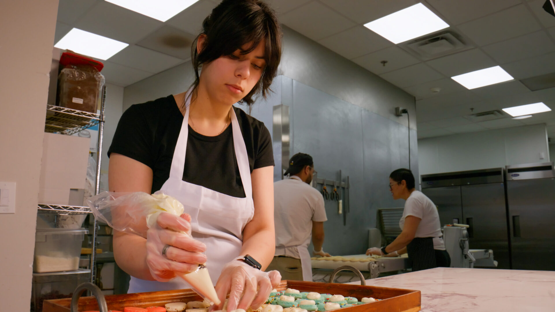 Baker preparing pastries by hand in the kitchen at French Press Bakery Needham MA